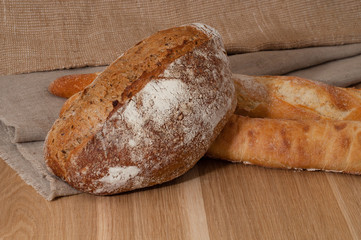 French bread and two baguettes on a background of cloth