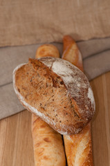 French bread and two baguettes on a background of cloth