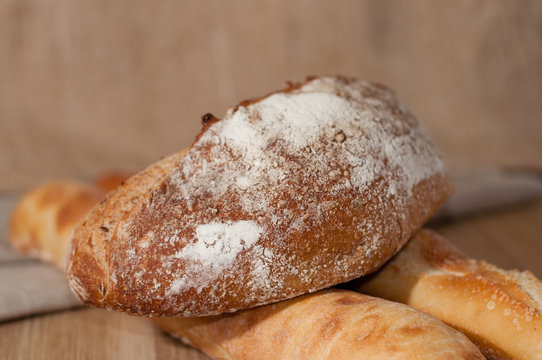 French bread and two baguettes on a background of cloth