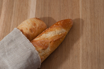 Two baguettes wrapped in a linen napkin