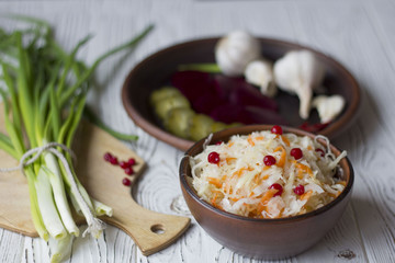Traditional Russian pickled cucumbers, onions, beets, chili, garlic, sauerkraut with cranberries on the table