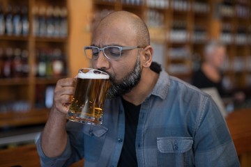 Man having glass of beer in restaurant
