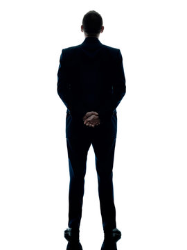 One Caucasian Business Man Standing Rear View Silhouette Isolated On White Background