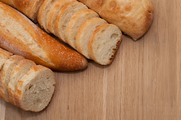 French loaf and ciabatta on a wooden board with space for text