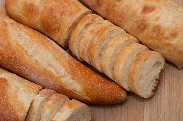 French loaf and ciabatta on a wooden board with space for text