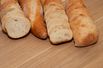 French loaf and ciabatta on a wooden board with space for text
