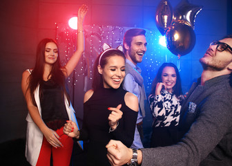 new year party, holidays, celebration, nightlife and people concept - Young people having fun dancing at a party