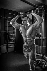 Naklejka na ściany i meble Sexy muscular man posing in gym, shaped abdominal. Strong male n
