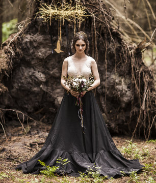 Portrait Of A Bride Dressed In Non Traditional Wedding Dress Outdoors In The Woods