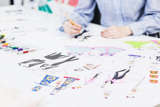 Young designer draws sketches of clothes.