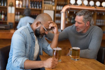 Man comforting his depressed friend