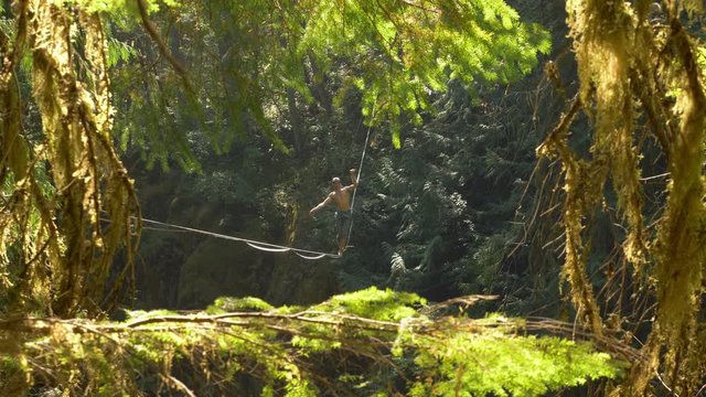 Fit Man Highlining Over A Waterfall In Oregon