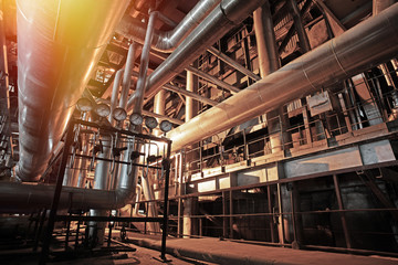 Equipment, cables and piping as found inside of a modern industrial power plant