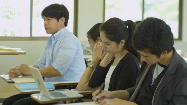 Young people are yawning and feeling sleepy in the lecture during a presentation
