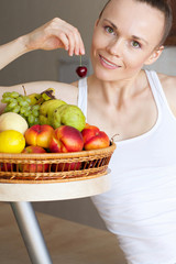 Young woman is eating fruits