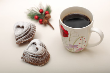 High angle view of heart shape  cookies with a mug of hot coffee, and twig of fir tree