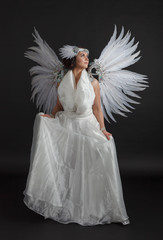 Young woman in carnival costume with wings .