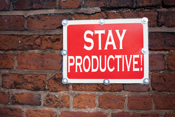 Hand writing text caption inspiration showing Stay Productive concept meaning Concentration Efficiency Productivity written on old announcement road sign with background and copy space