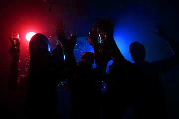 Young happy people are dancing in club. Nightlife and disco concept.