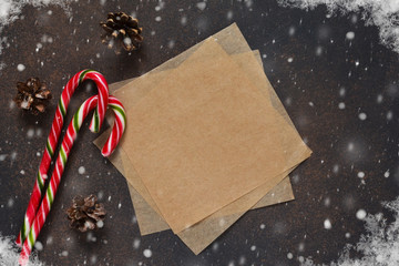 New Year card. Christmas tree with cones and candies on a brown background with space under the text.