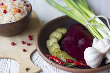 Traditional Russian pickled cucumbers, onions, beets, chili, garlic, sauerkraut with cranberries on the table