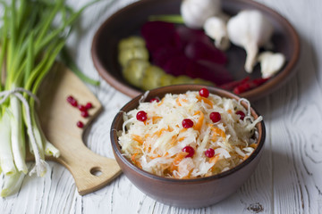 Traditional Russian pickled cucumbers, onions, beets, chili, garlic, sauerkraut with cranberries on the table