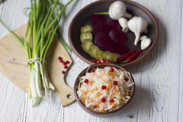 Traditional Russian pickled cucumbers, onions, beets, chili, garlic, sauerkraut with cranberries on the table