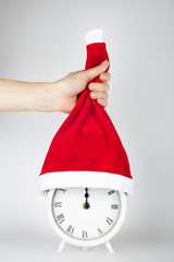 Vintage alarm clock in Santa Claus hat.