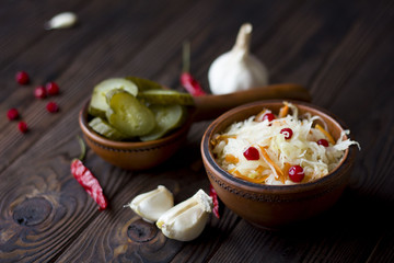 sauerkraut with cranberries and vegetables : garlic, cucumber, chili peppers on the table