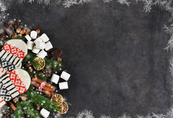 Ingredients for hot chocolate on a black background. Warm winter drink. Happy New Year and Merry Christmas.