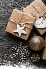 Fototapeta na wymiar Christmas background with presents, snow and decoration on concrete.