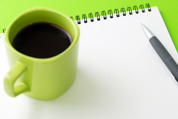 Blank notepad with a cup of coffee and pen