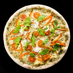 Traditional delicious Italian pizza with tomato, cheese, pepper and basil on dark background. Top view, flat lay