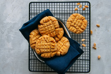 Homemade peanut butter cookies on a wire rack. Gray background. Rustic style.