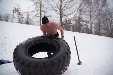 Sledgehammer Tire Hits men workout at gym with hammer and tractor tire