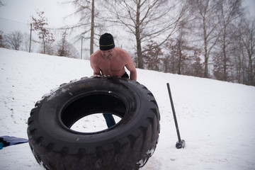 Sledgehammer Tire Hits men workout at gym with hammer and tractor tire
