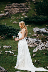 Fototapeta na wymiar Young blonde bride in the beautiful Alps 