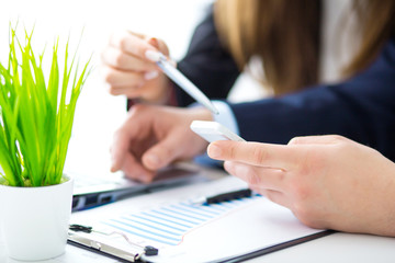 Image of two young businessmen working together on project at office