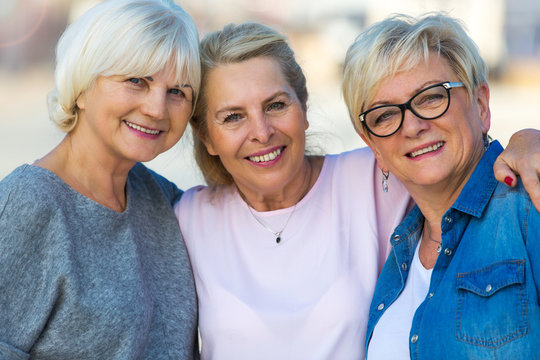 Group Of Smiling Senior Women Standing Outside
