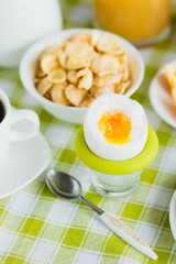 Soft boiled chicken egg, coffee, muesli and orange juice