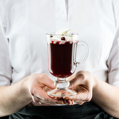The unidentified waiter brings a hot cocktail with whipped cream and lemon juice