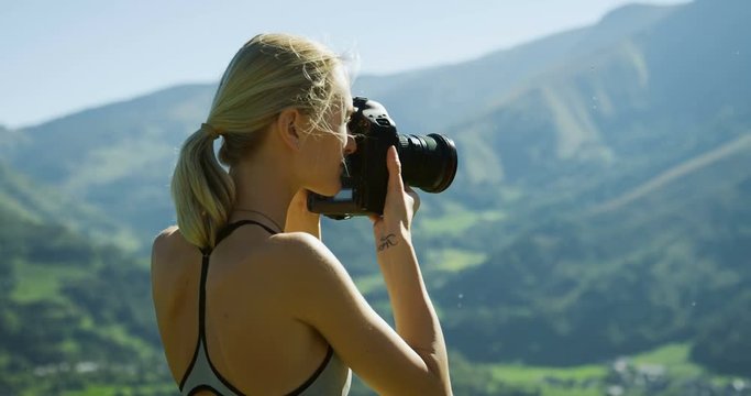 Fit Young Blonde Woman in Sportswear Takes Professional Pictures with Her DSLR Camera