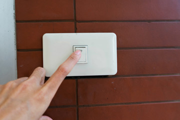 hand switching light power switch on or off.