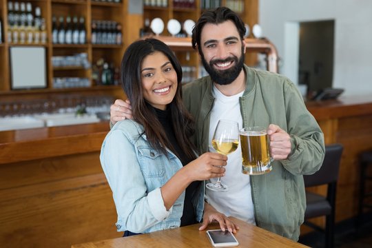 Smiling couple having drinks in bar