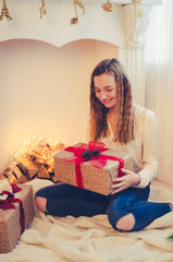 Teenage girl opening the present