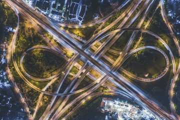 Rush hour traffic on a city roads. Modern metropolis with intersection of the traffic trails on a...