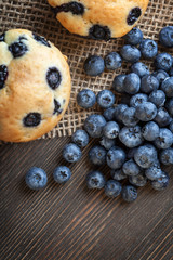 muffin with blueberries on a wooden table. fresh berries and sweet pastries on the board.