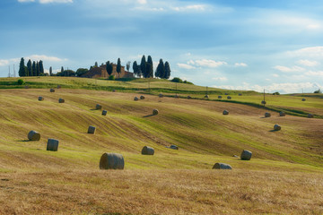 Obraz premium Stunning Tuscany landscape, typical stone house and hay bale on the hills,near Val d'Orcia, Italy, Europe