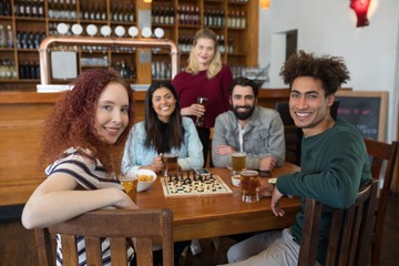 Friends having glass of beer in bar