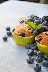 muffin with blueberries on a wooden table. fresh berries and sweet pastries on the board. © Chepko Danil